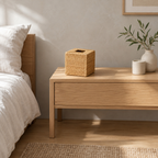 Woven rattan cube tissue box cover in Natural Rattan on an oak bedside table in a calm room