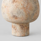 Close up of the cylindrical pedestal foot of the textured ceramic vase.