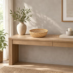 Woven rattan round basket tray in Natural Rattan on an oak console table in a calm room