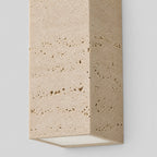 Close up of the natural pitted face of the yellow travertine block wall sconce