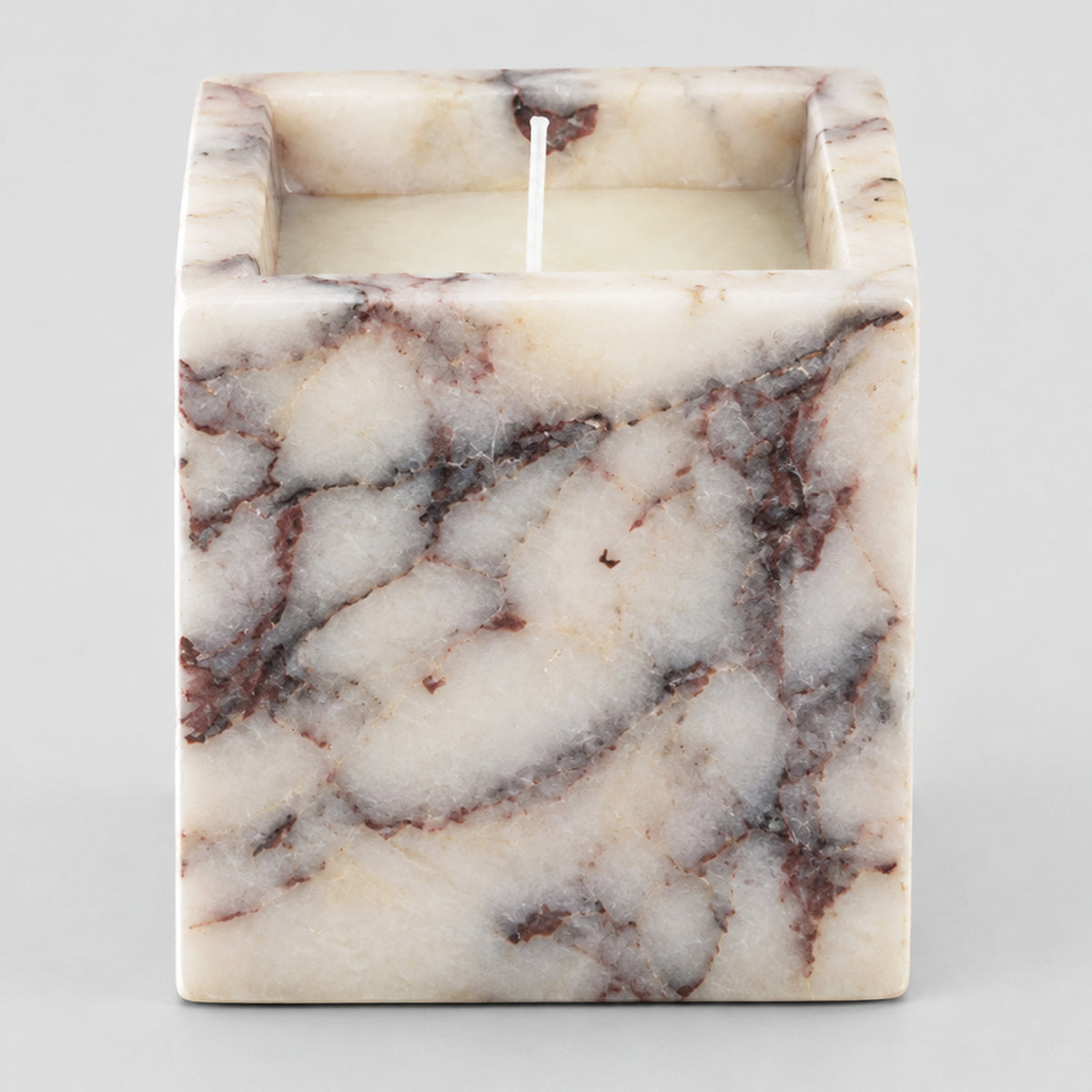 Calacatta Viola square marble candle holder on a light gray studio background.