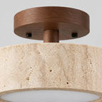 Close up of the finish at a seam of the metal body of the travertine drum flush mount ceiling light