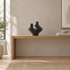 Dual-neck abstract ceramic vase on an oak console table in a calm room