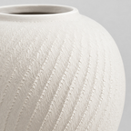 Close up of the chattered spiral surface texture of the textured ceramic vase in Matte White.