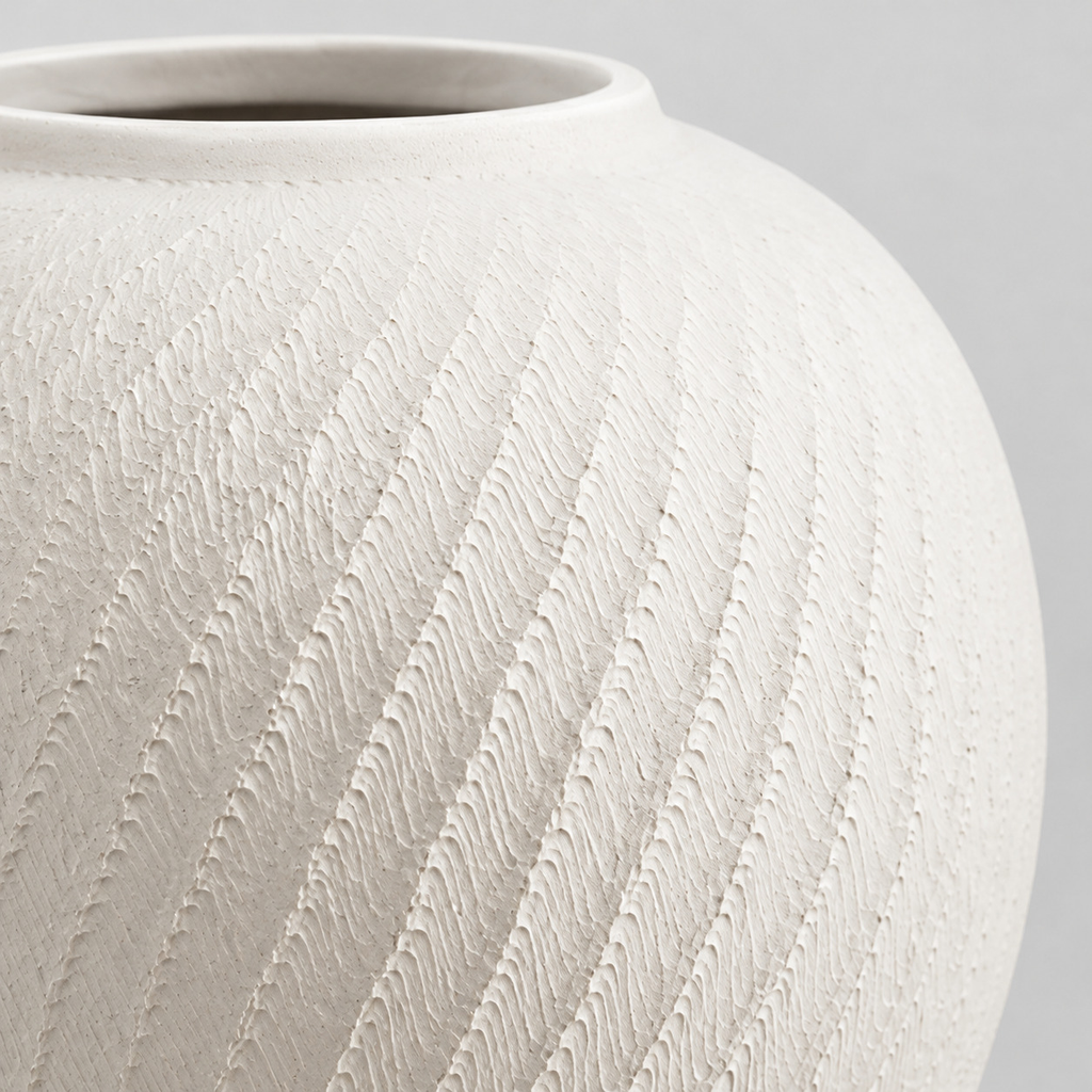 Close up of the chattered spiral surface texture of the textured ceramic vase in Matte White.