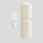 Dual-light ceramic wall sconce in a white finish on a light gray studio background