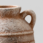 Close up of the small looped ceramic handle of the double-handled ceramic amphora vase.