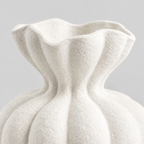 Close up of the ruffled petal rim of the fluted ceramic vase in Matte White.