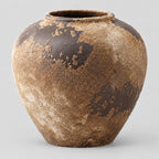 Weathered ceramic vase in Weathered Brown on a light gray studio background.