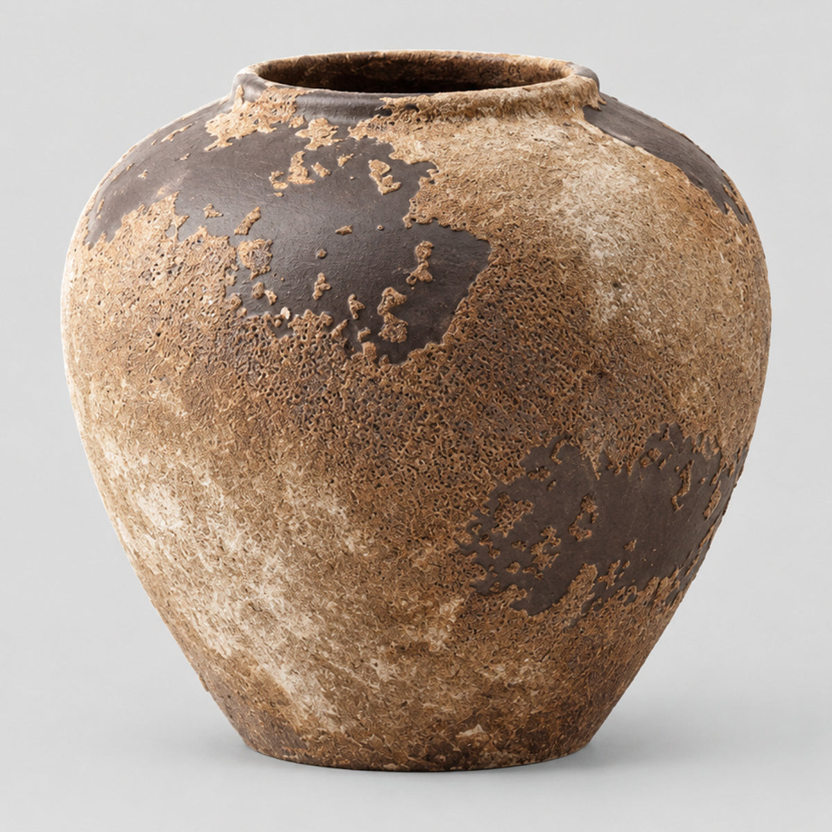 Weathered ceramic vase in Weathered Brown on a light gray studio background.
