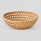 Woven rattan round basket tray in Natural Rattan on a light gray studio background