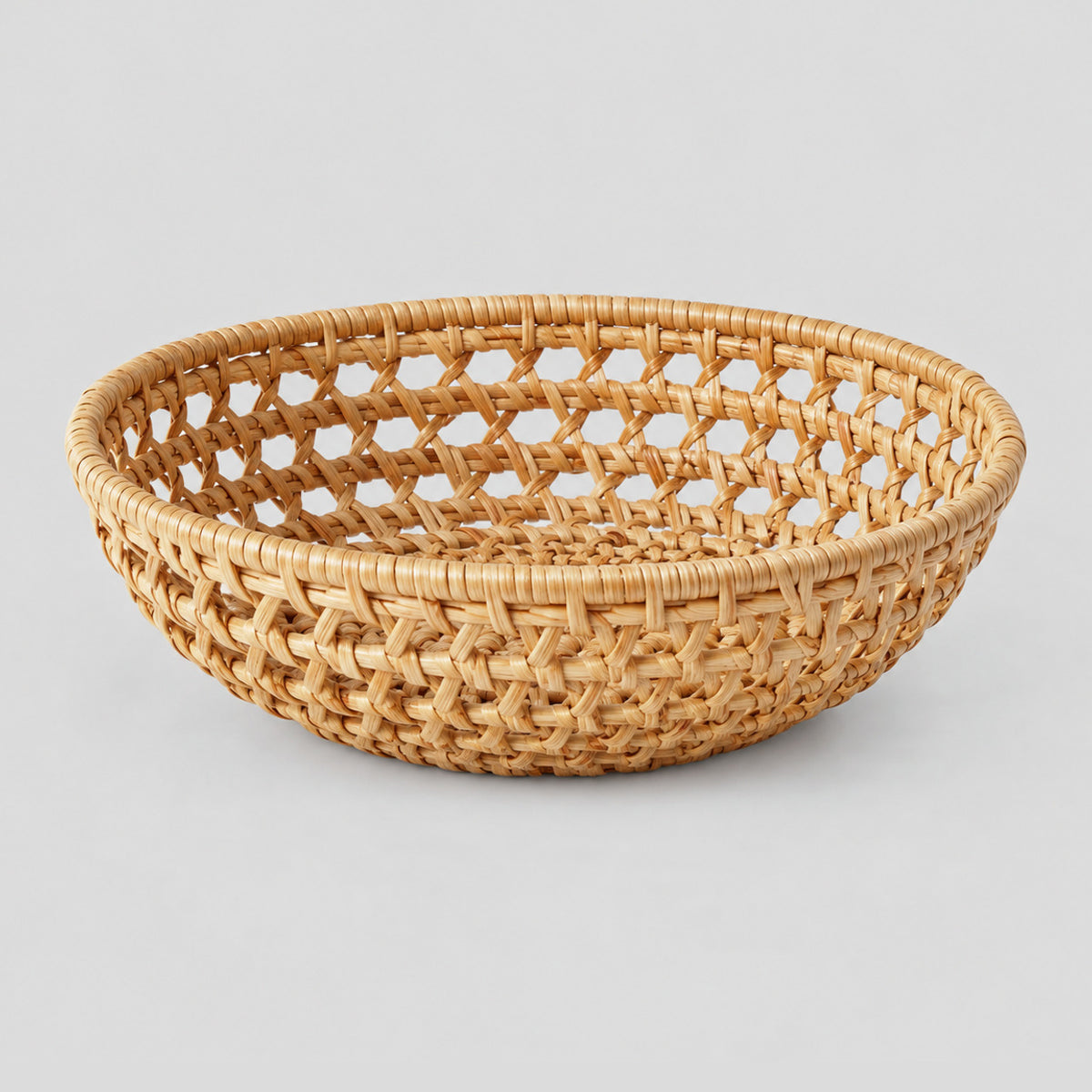 Woven rattan round basket tray in Natural Rattan on a light gray studio background