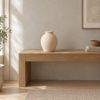 Off-white ribbed ceramic vase on a 120 cm wide oak console table in a calm room.