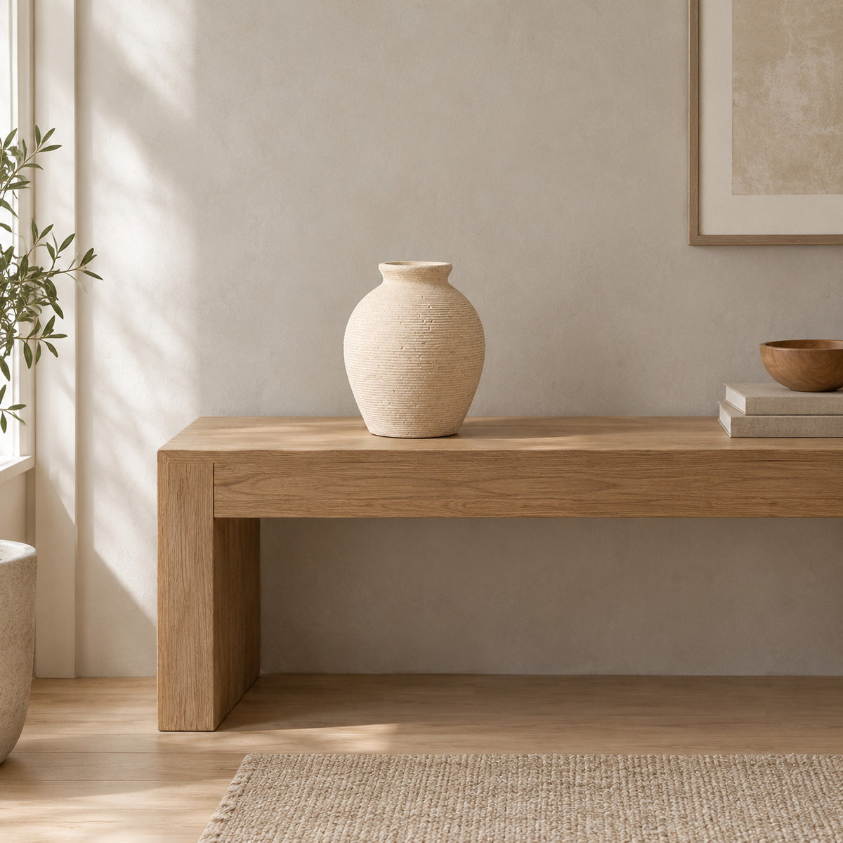 Off-white ribbed ceramic vase on a 120 cm wide oak console table in a calm room.