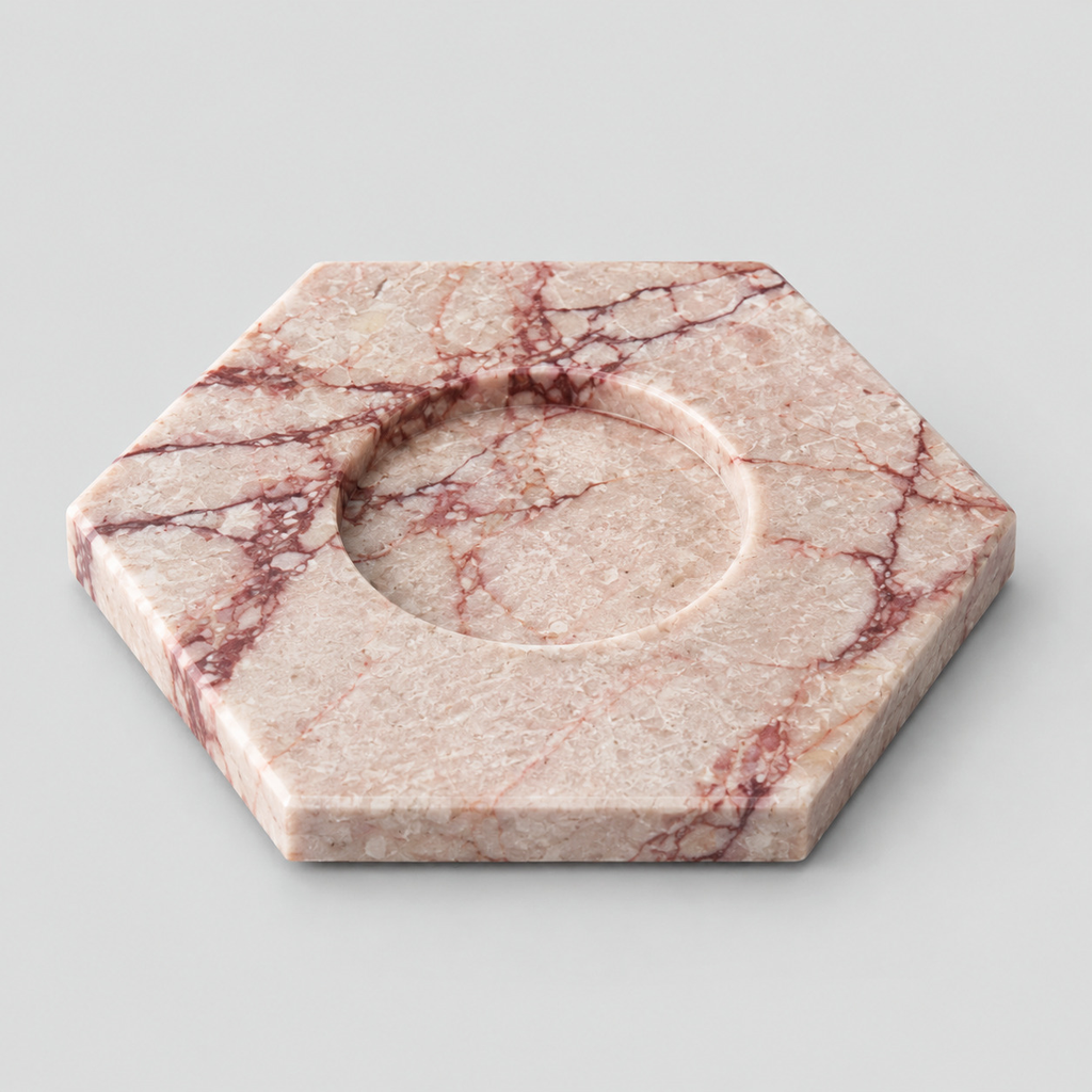 Rose Marble hexagonal marble candle holder on a light gray studio background.