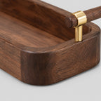 Close up of the rounded corner joint of the solid walnut rim of the serving tray.