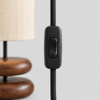 Close up of the inline switch on the cord of the Walnut stacked wood table lamp