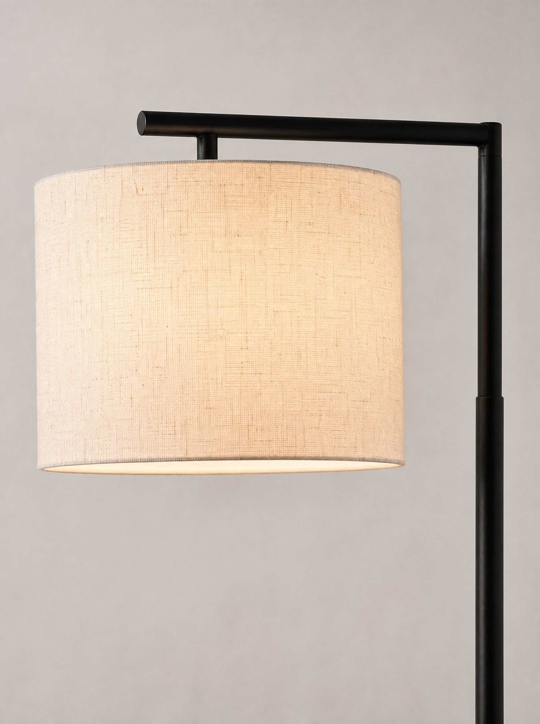Close up of the fabric weave of the drum shade and the black arc arm