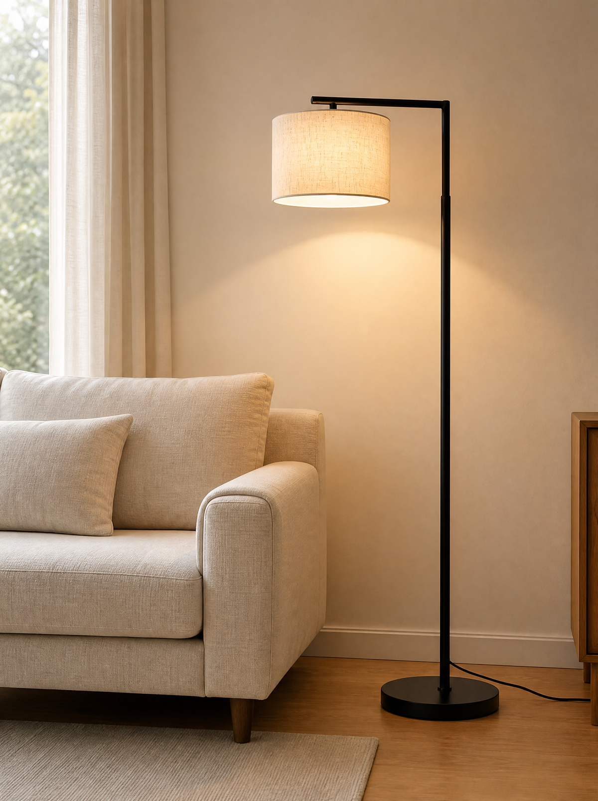 Arc floor lamp lit over the end of a linen sofa in a living room