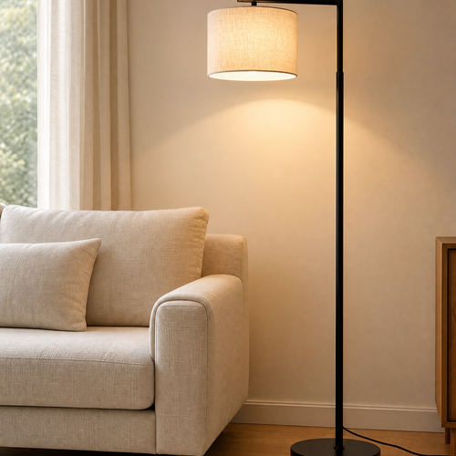 Arc floor lamp lit over the end of a linen sofa in a living room
