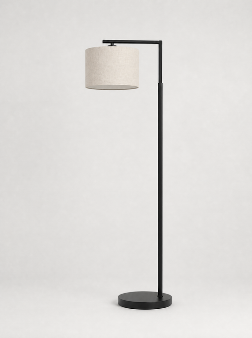 Black arc floor lamp with a cream fabric drum shade on a light gray studio background