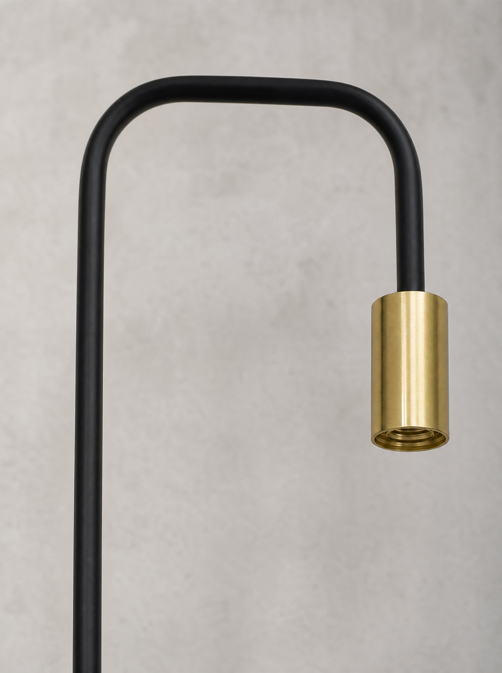 Close up of the empty brass socket at the end of the curved black arm