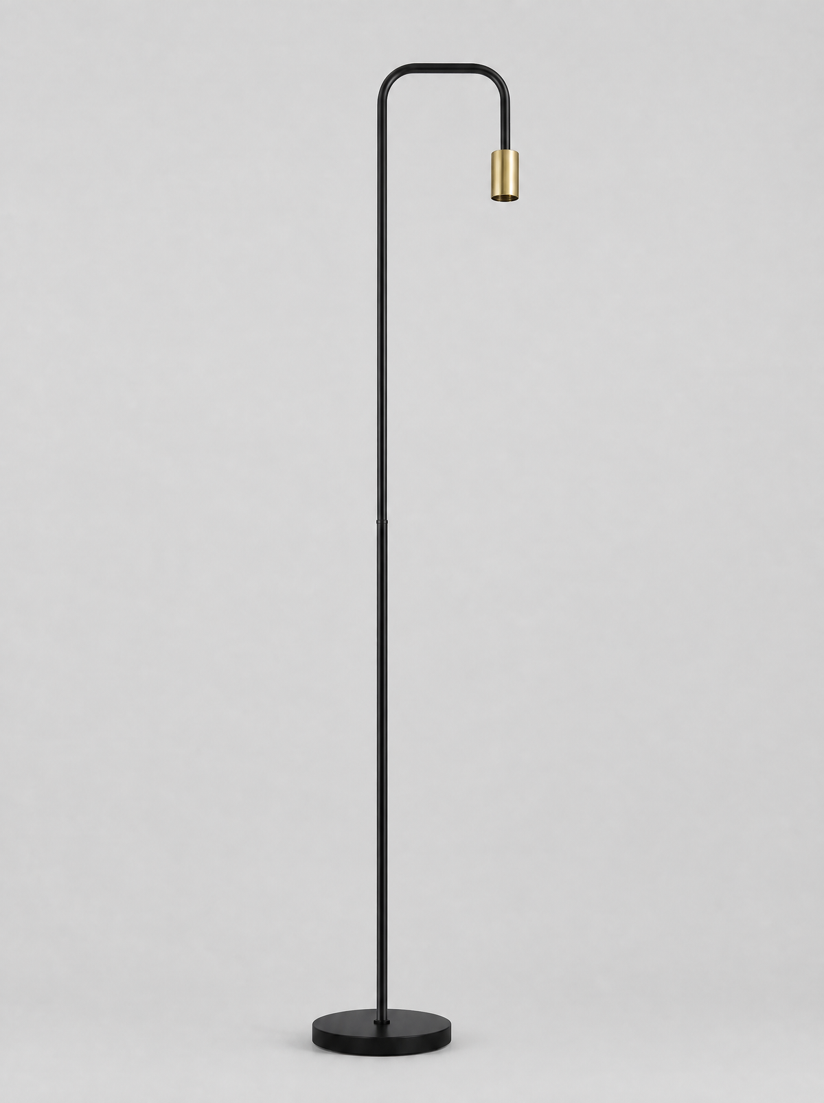 Black floor lamp with a curved arm and an open brass socket on a light gray studio background