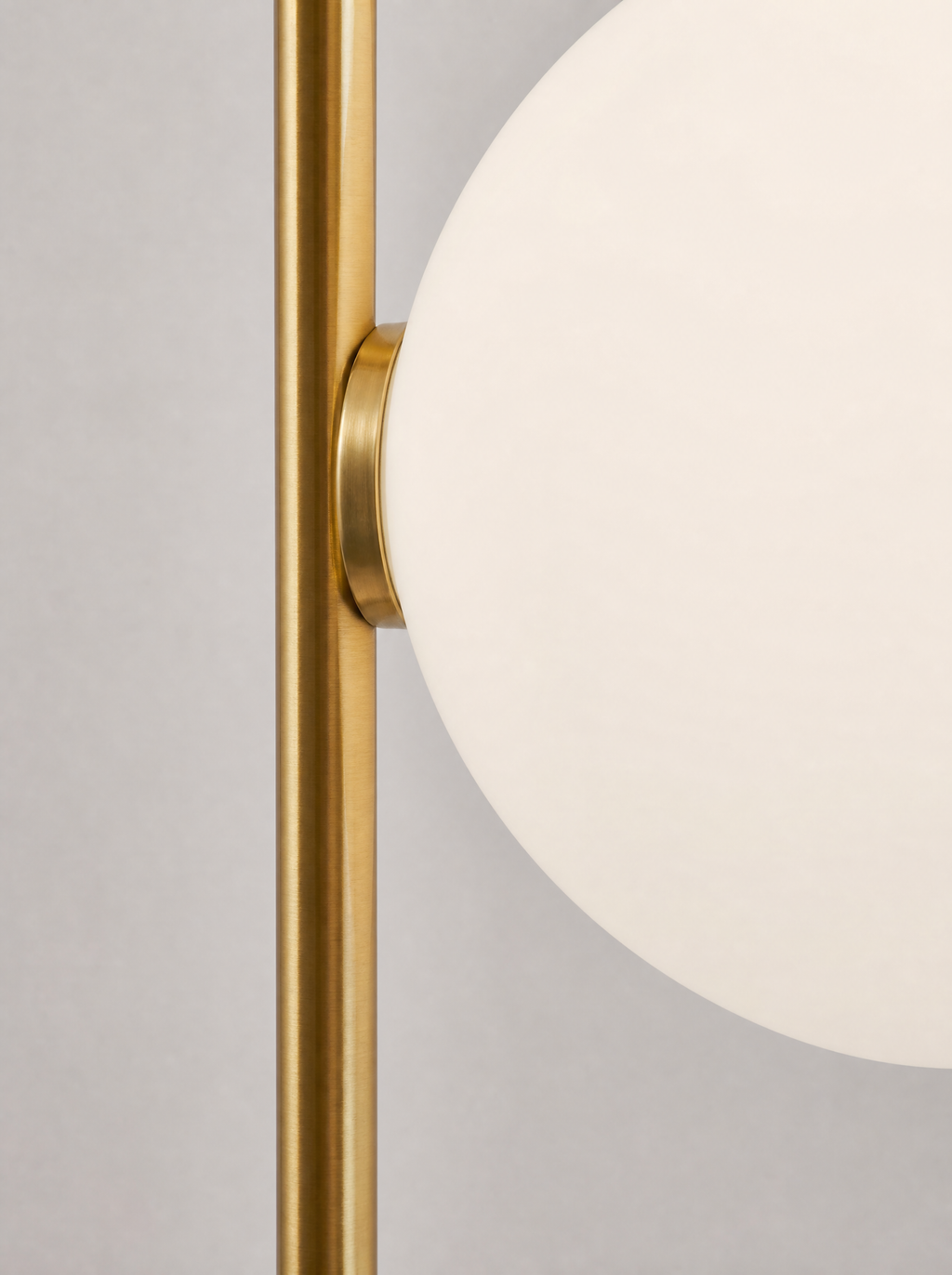 Close up of one opal globe where it meets the brass pole