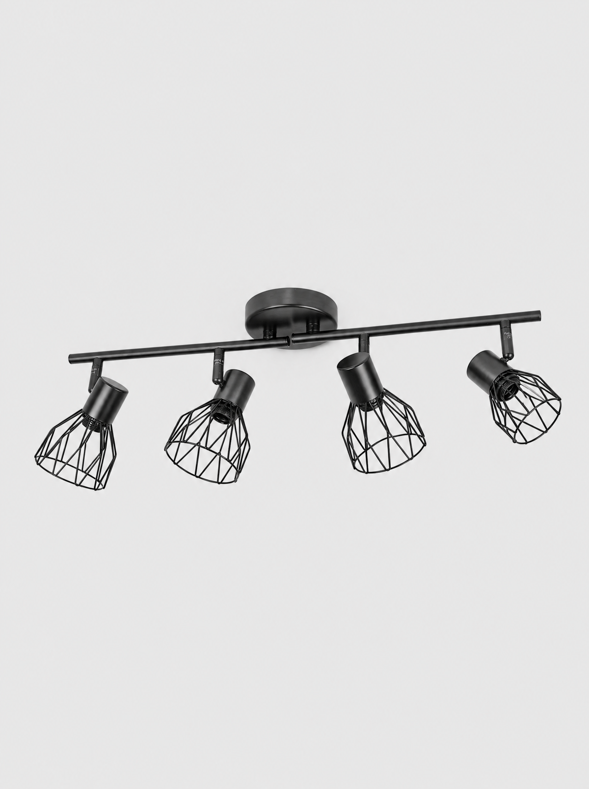 Black four head ceiling spot bar with wire cage shades on a light gray studio background