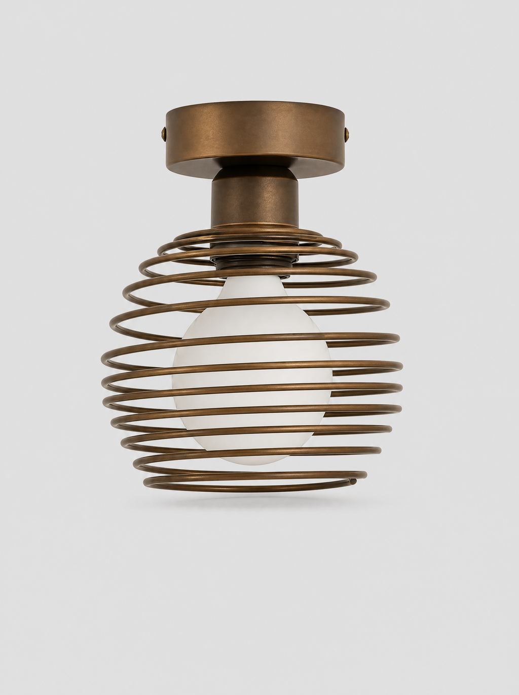 Black coiled metal flush ceiling light with an opal glass globe on a light gray studio background