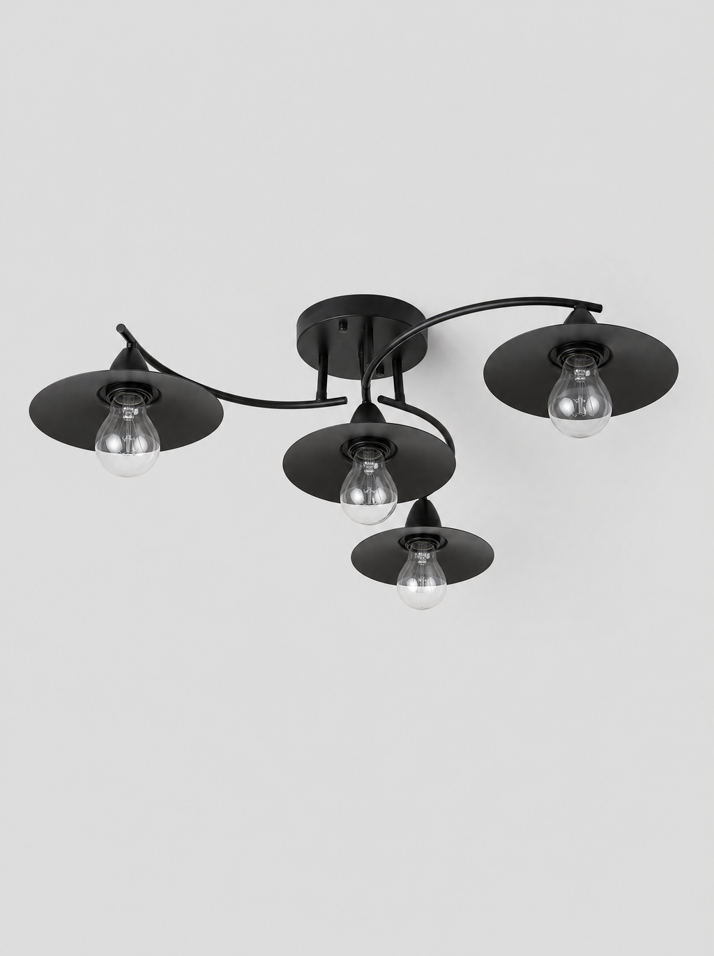Black four light flush ceiling fixture with cone shades on a light gray studio background