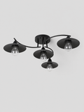 Black four light flush ceiling fixture with cone shades on a light gray studio background