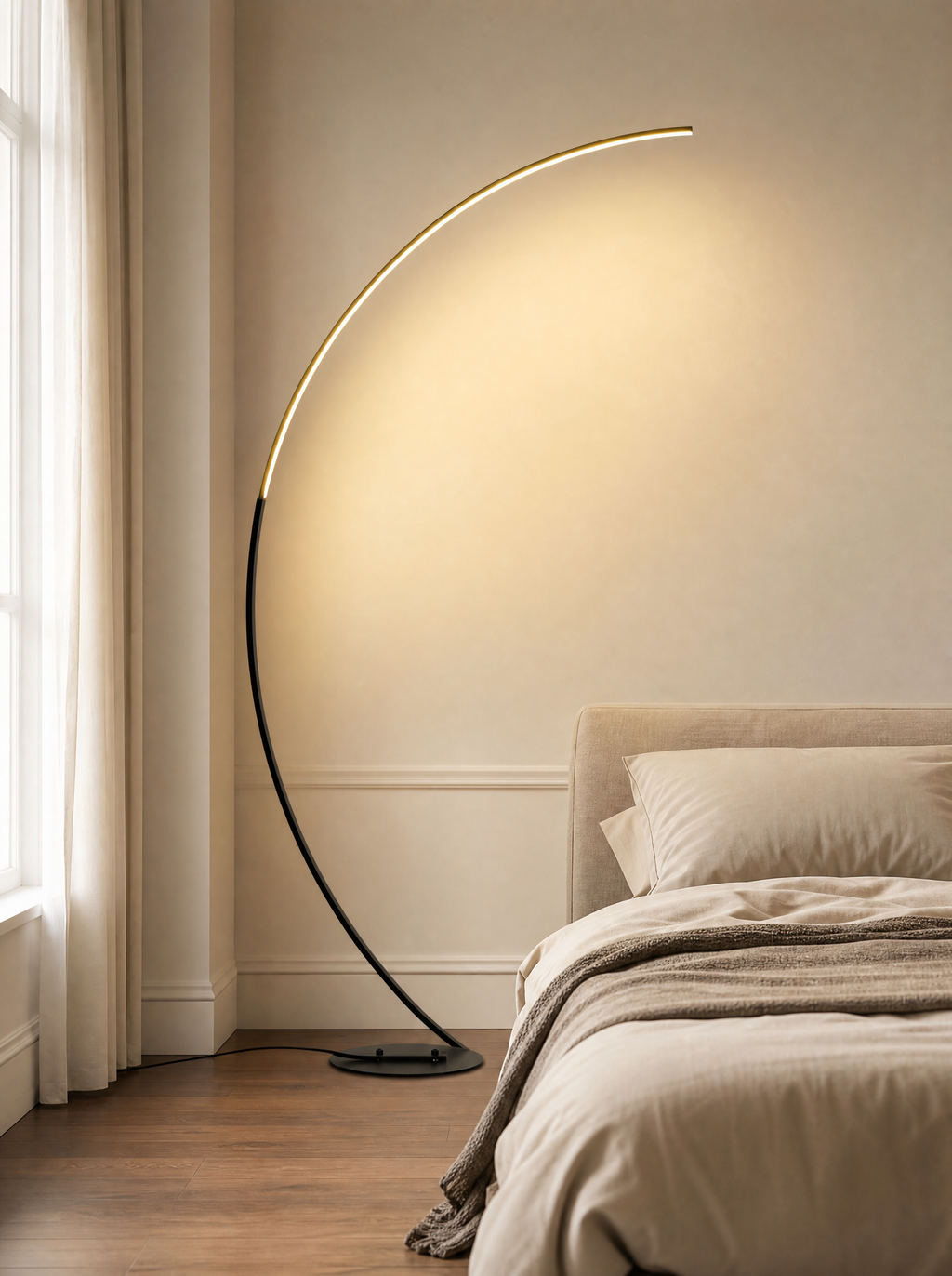 LED arc floor lamp lit over a bed in a quiet bedroom