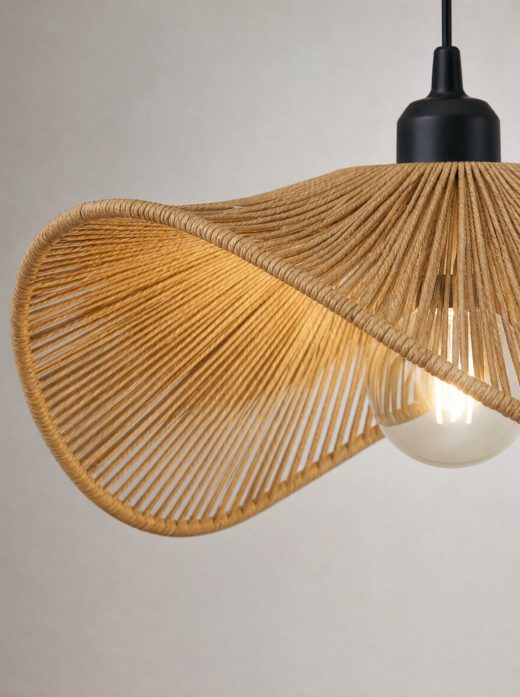 Close up of the radiating weave and irregular edge of the rattan brim pendant