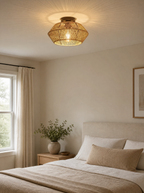Rattan drum semi flush ceiling light lit on the ceiling of a calm bedroom