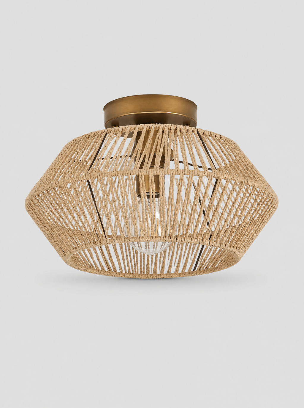 Hand woven rattan drum semi flush ceiling light on a light gray studio background