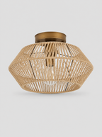 Hand woven rattan drum semi flush ceiling light on a light gray studio background