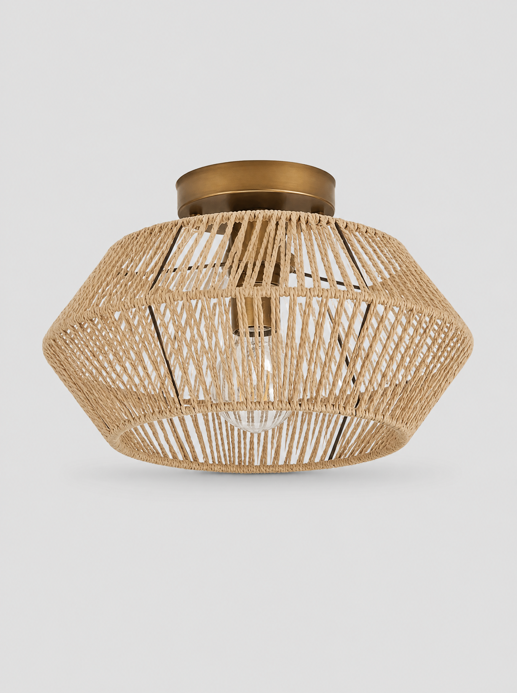 Hand woven rattan drum semi flush ceiling light on a light gray studio background