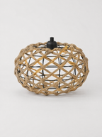 Open weave rattan oval pendant light on a light gray studio background