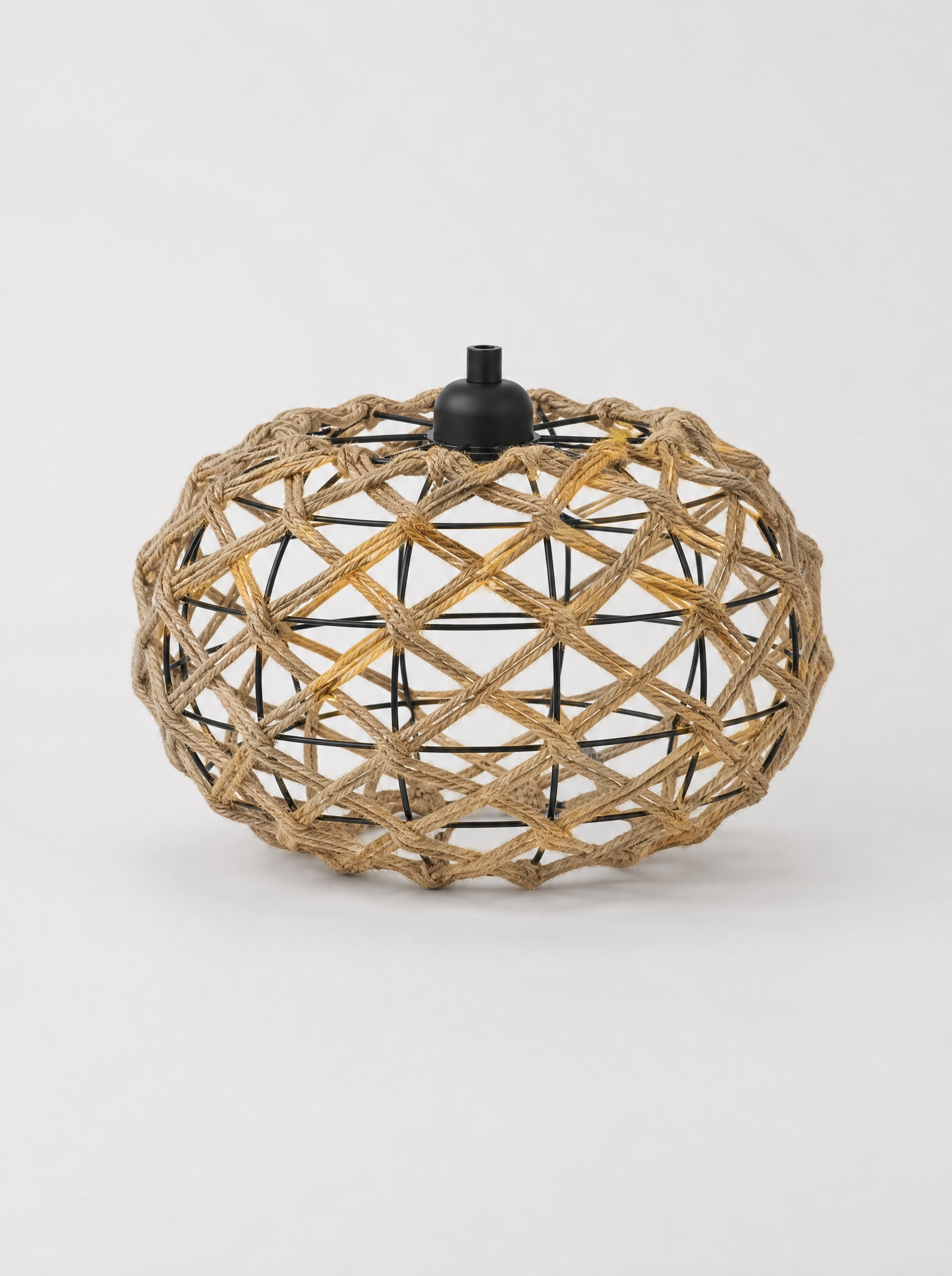 Open weave rattan oval pendant light on a light gray studio background