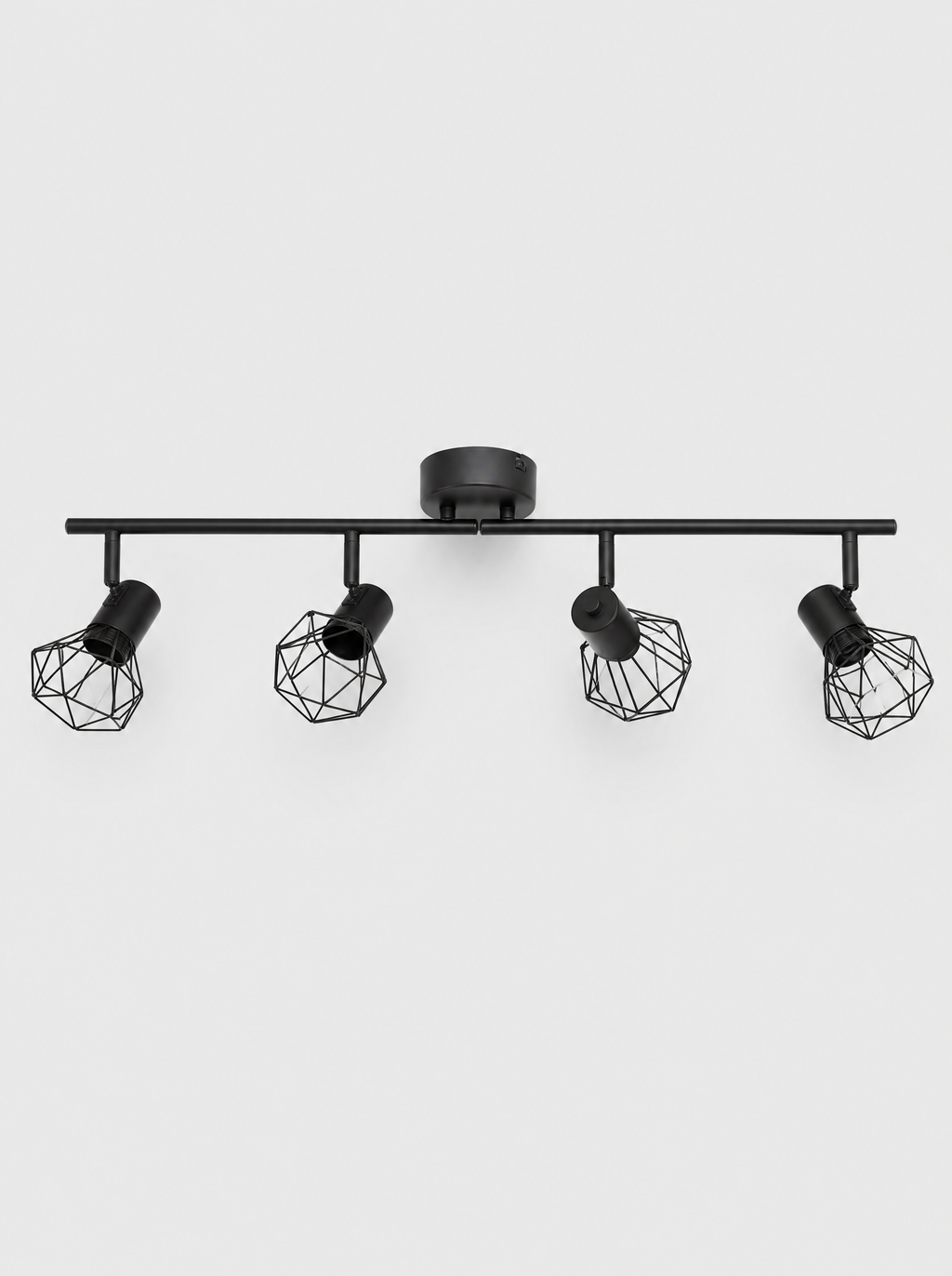 Black four head ceiling spot bar with rounded wire cage shades on a light gray studio background