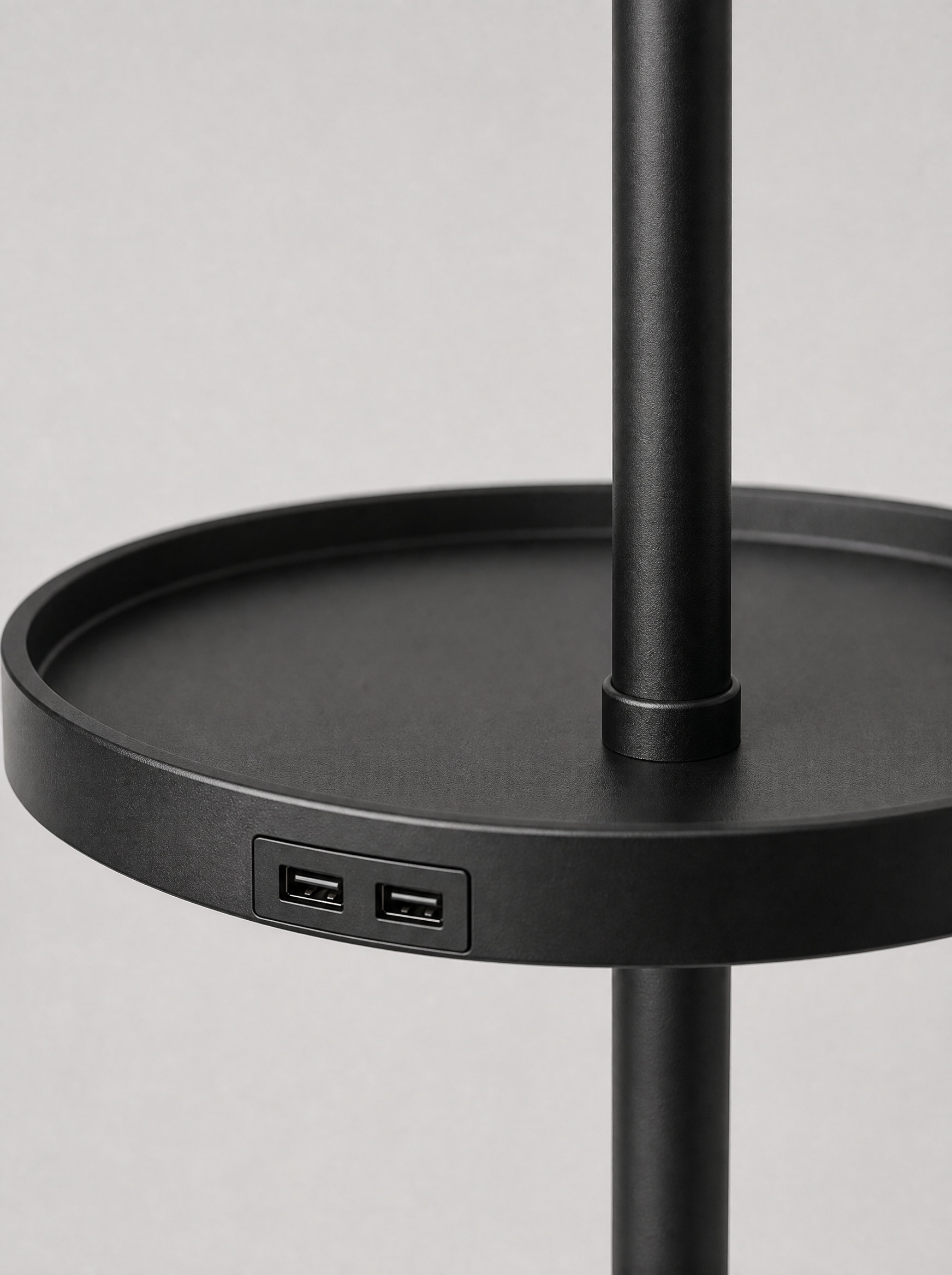 Close up of the round tray and the two USB ports set into the pole