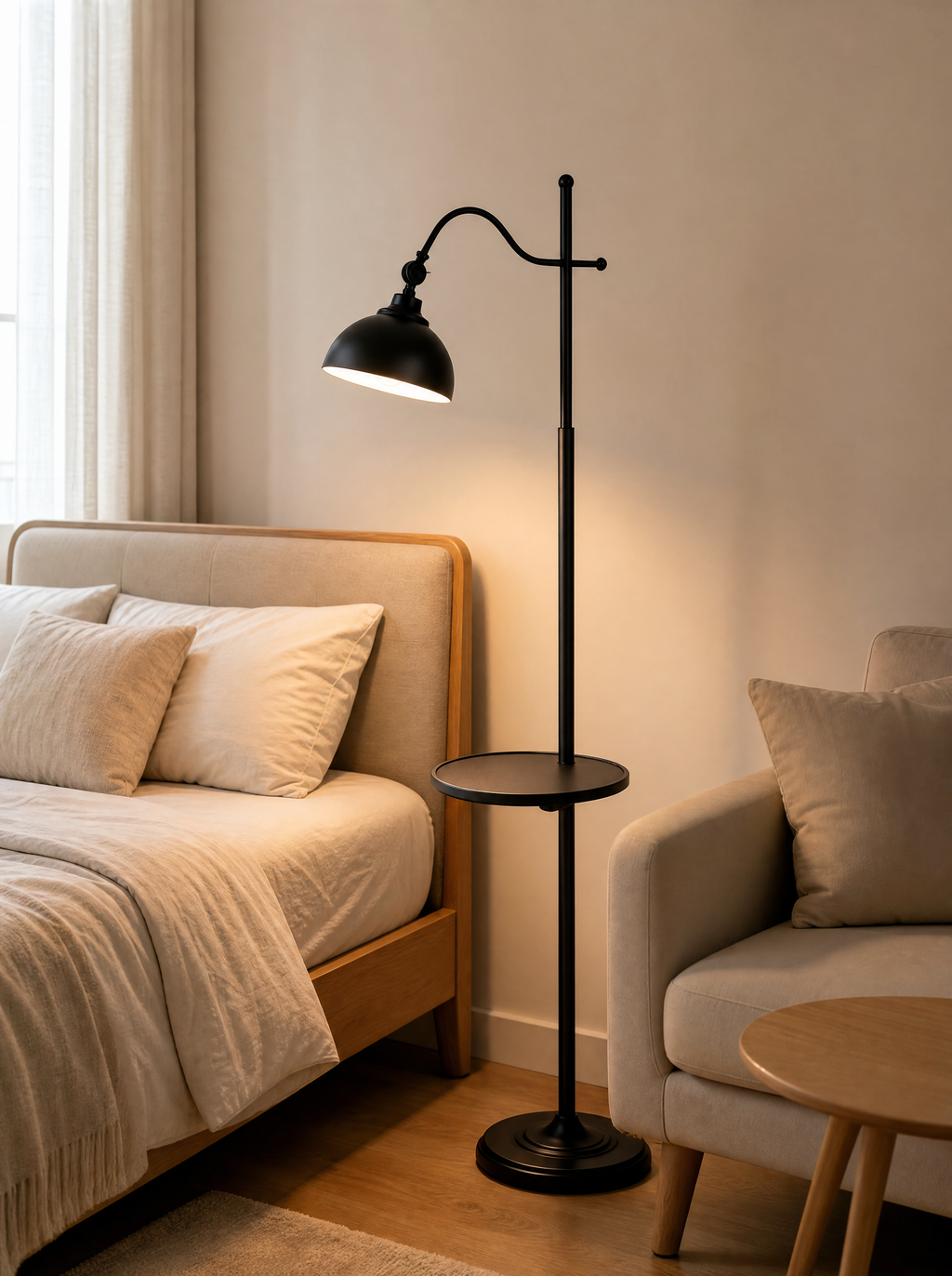 Tray floor lamp lit between a bed and an armchair in a bedroom