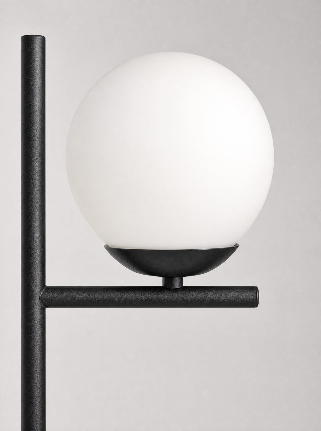 Close up of the opal globe seated on the flat black arm