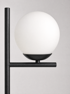 Close up of the opal globe seated on the flat black arm
