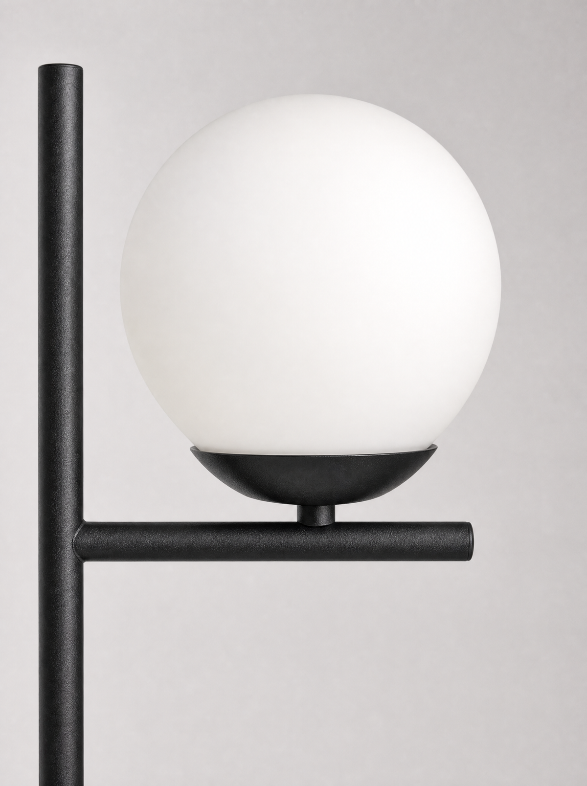 Close up of the opal globe seated on the flat black arm