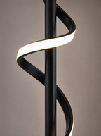 Close up of the twist in the lit ribbon against the black column
