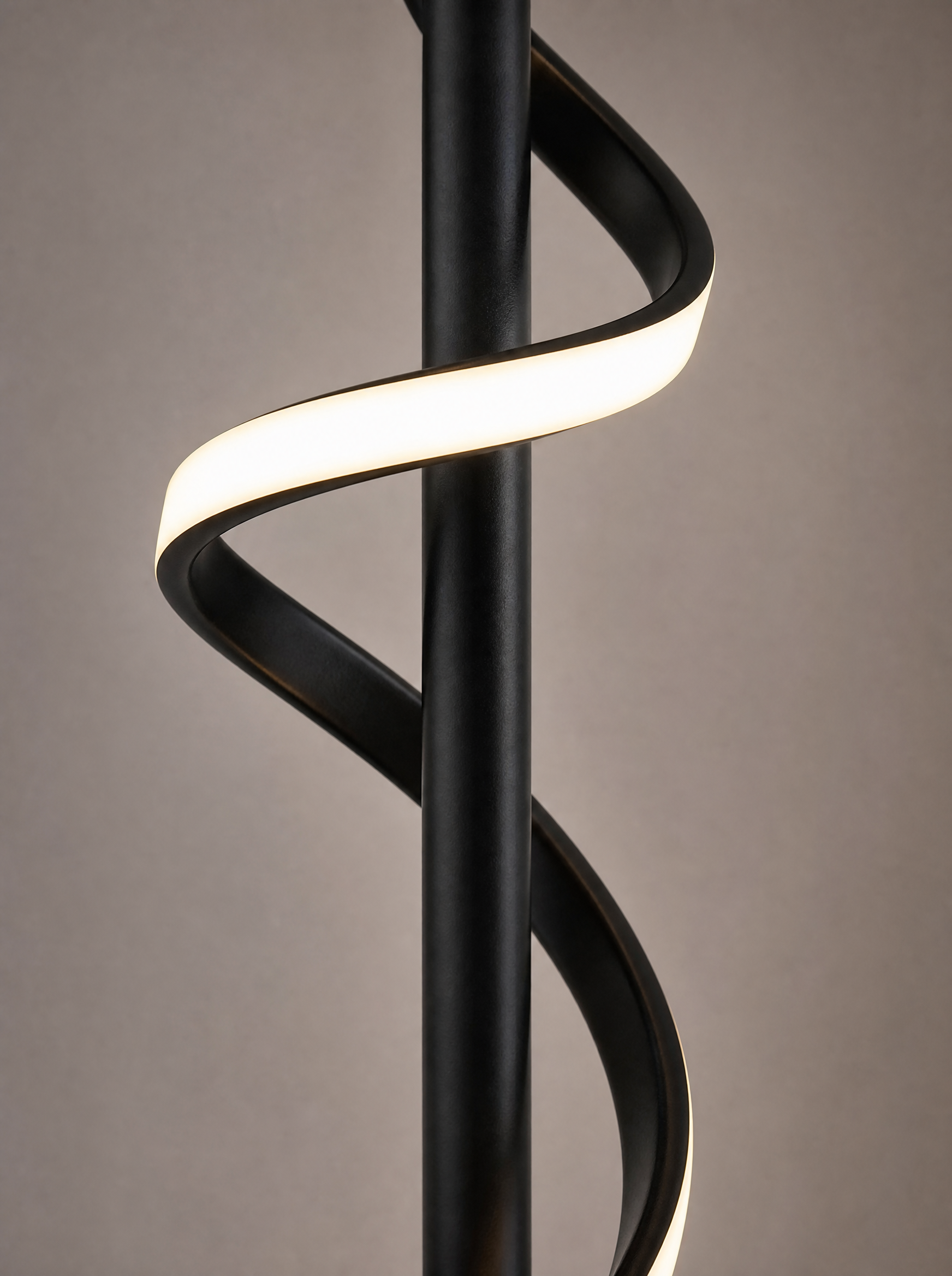 Close up of the twist in the lit ribbon against the black column