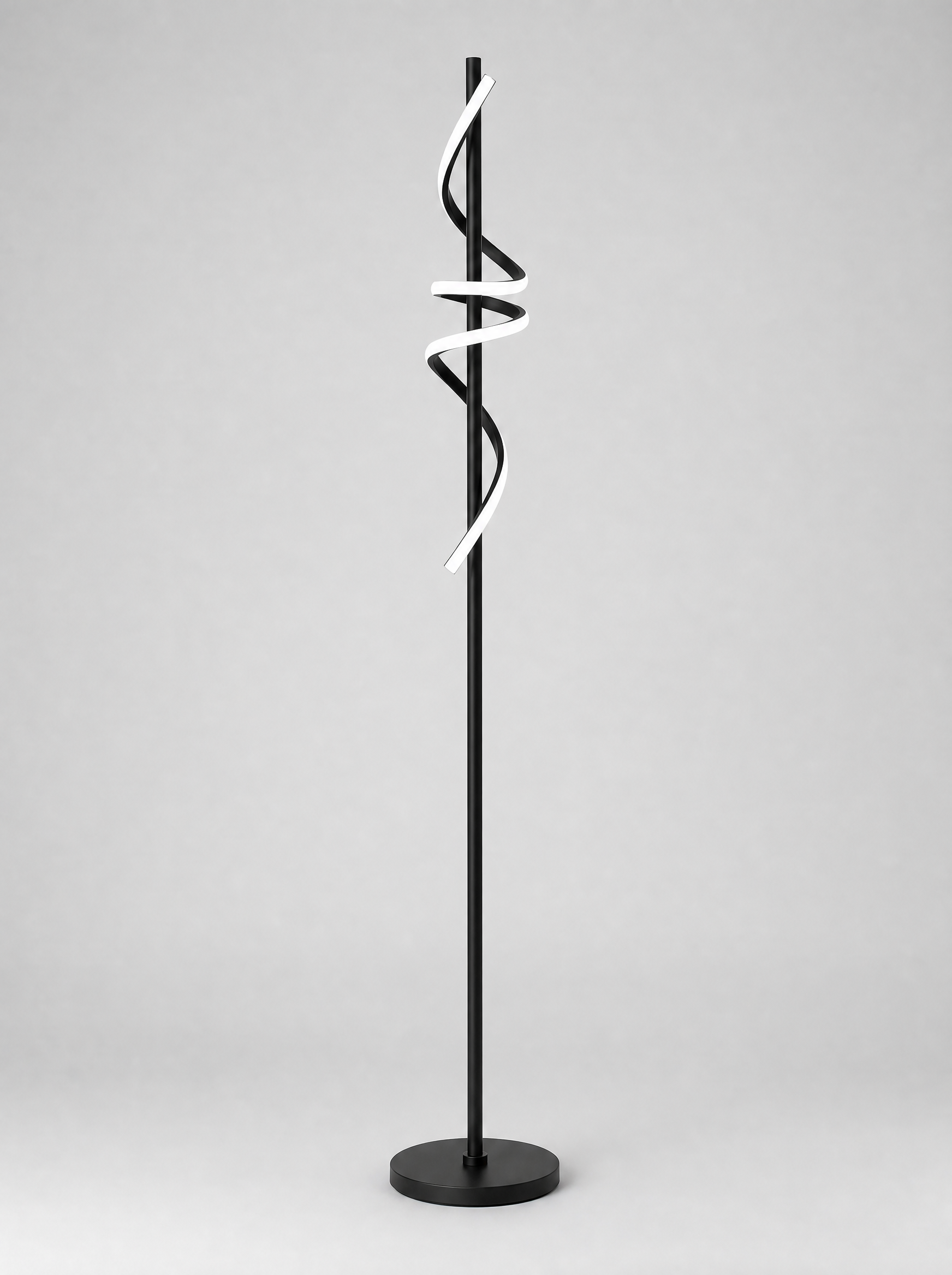 Black twisted ribbon LED floor lamp on a light gray studio background