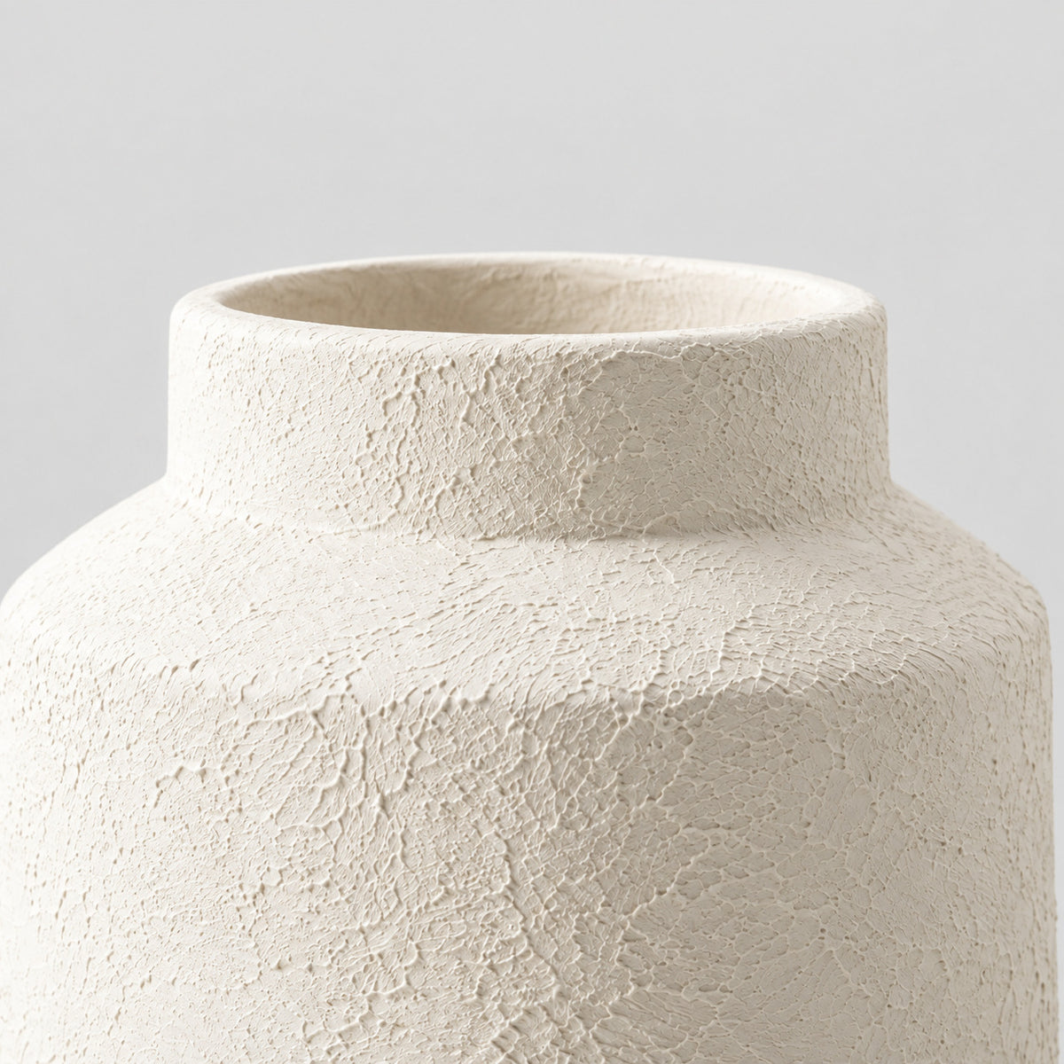 Close up of the short cylindrical collar and rim of the Textured White ceramic jar vase.